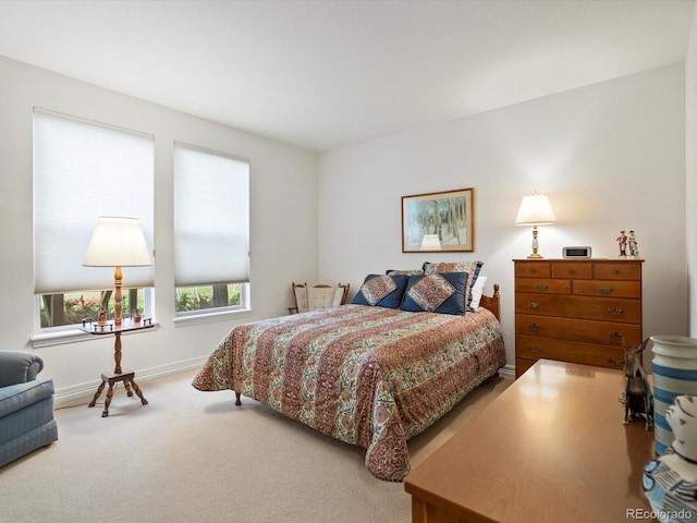 carpeted bedroom featuring baseboards