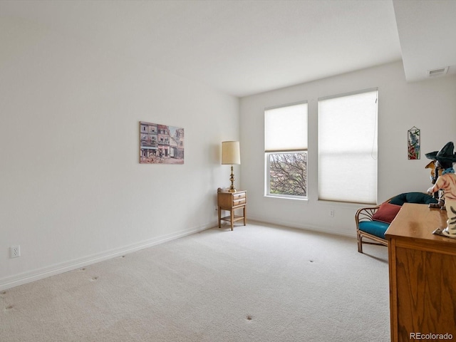 sitting room with visible vents, carpet flooring, and baseboards