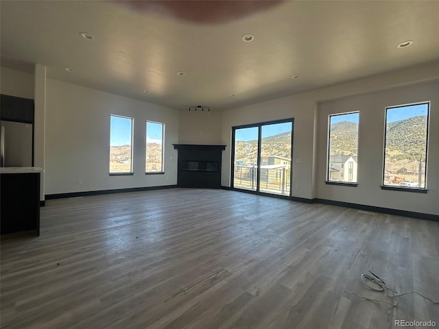 unfurnished living room with dark hardwood / wood-style flooring