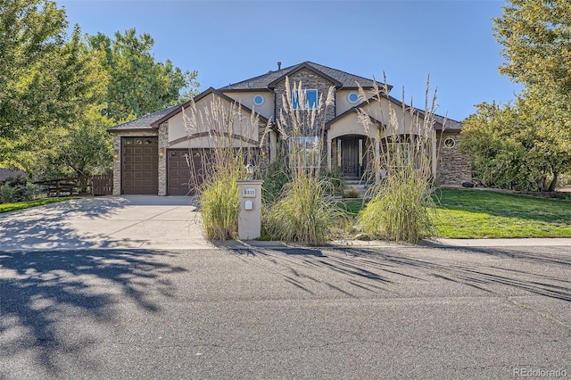 view of front of property featuring a garage and a front yard