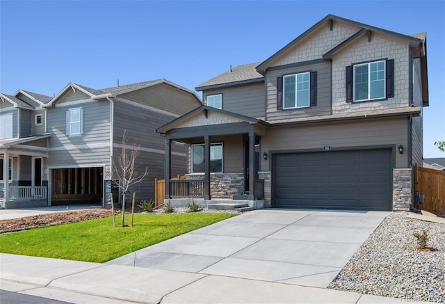 craftsman-style home with a porch, a garage, and a front lawn