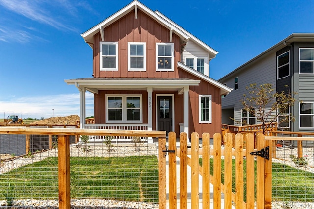 2651 E 102nd Pl, Thornton, CO 80229 - view of front of home with covered porch, board and batten siding, a fenced front yard, and a gate