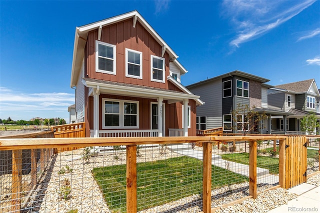 2651 E 102nd Pl, Thornton, CO 80229 - view of front of house featuring board and batten siding, covered porch, and a fenced front yard