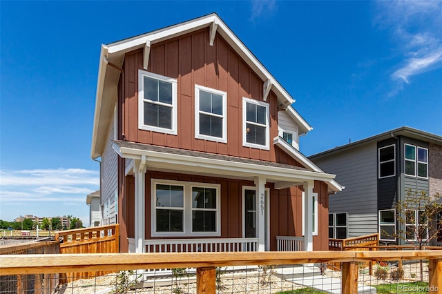 2651 E 102nd Pl, Thornton, CO 80229 - view of front of property with board and batten siding, a porch, and a fenced front yard