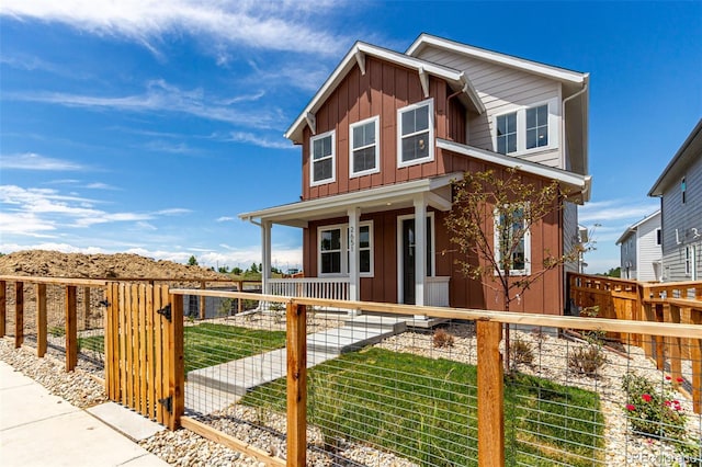 2651 E 102nd Pl, Thornton, CO 80229 - view of front facade with a porch, board and batten siding, a fenced front yard, and a gate
