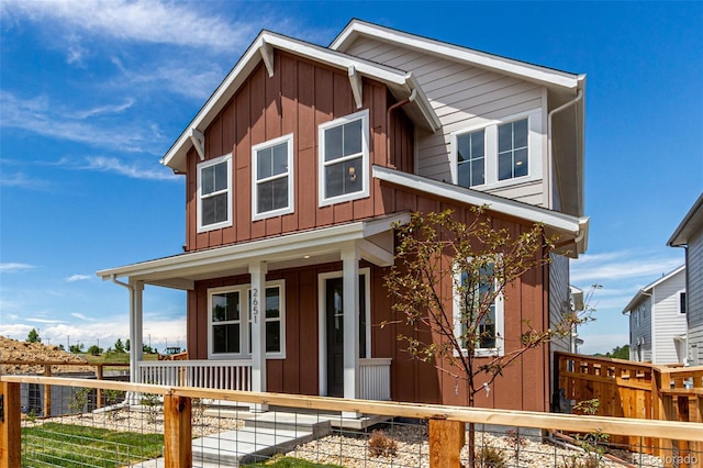 2651 E 102nd Pl, Thornton, CO 80229 - view of front of home with a porch, board and batten siding, and a fenced front yard