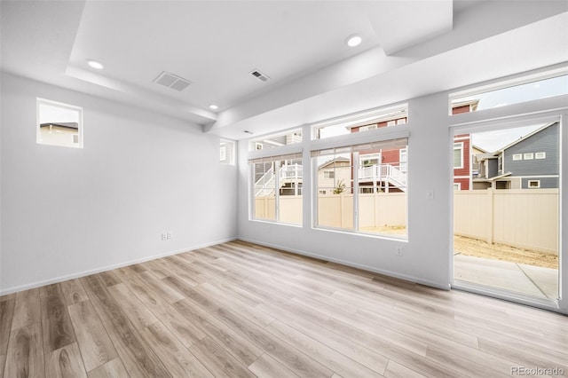 unfurnished room with recessed lighting, visible vents, baseboards, and wood finished floors