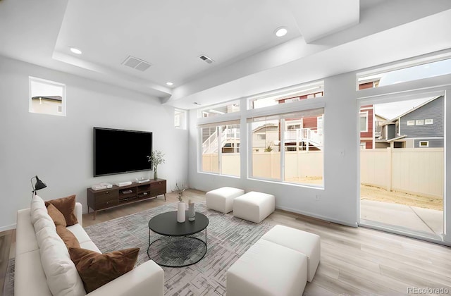 living area featuring recessed lighting, wood finished floors, and visible vents