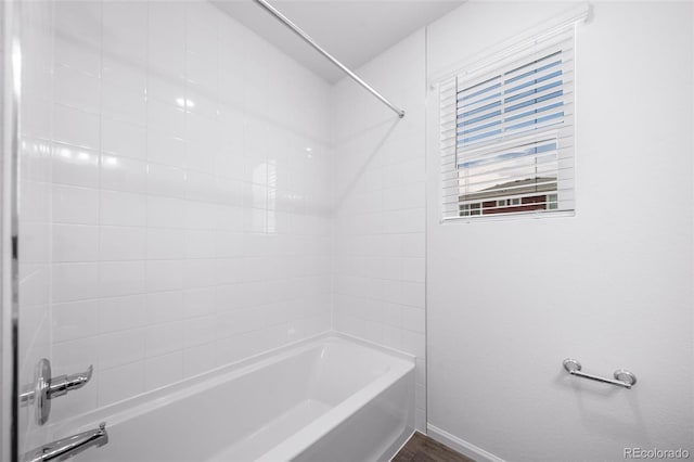 full bathroom featuring tub / shower combination and baseboards