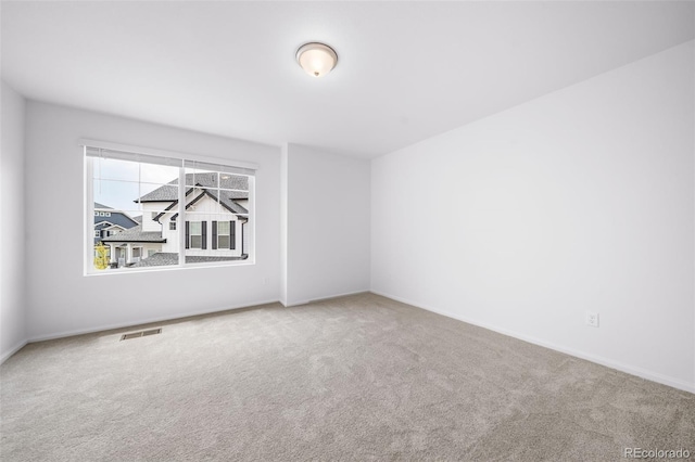 spare room with visible vents and carpet flooring