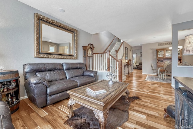 living room featuring a textured ceiling and light hardwood / wood-style floors