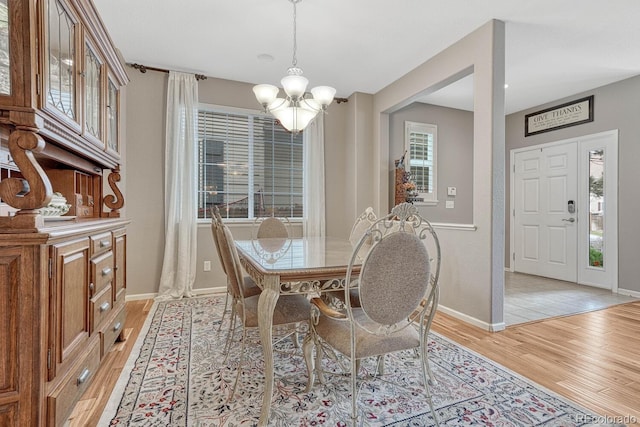 dining area featuring a notable chandelier and light hardwood / wood-style floors