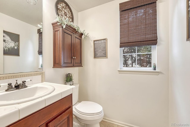 bathroom with vanity, tile patterned flooring, and toilet