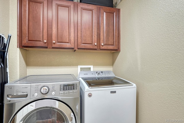 laundry area featuring cabinets and washer and dryer