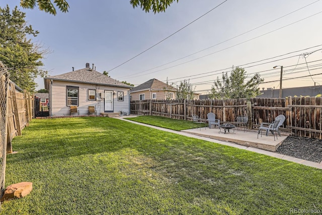 yard at dusk featuring a patio area