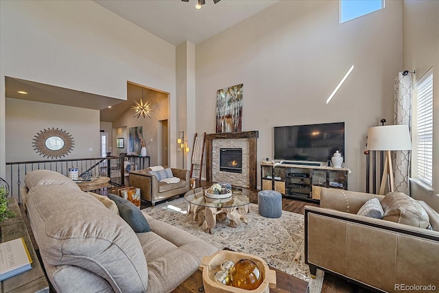 12590 Valentia St, Thornton, CO 80602 - living room featuring a high ceiling, wood finished floors, and a glass covered fireplace