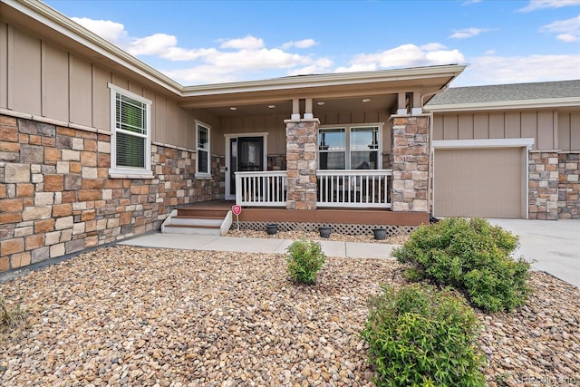 12590 Valentia St, Thornton, CO 80602 - doorway to property with a porch, board and batten siding, stone siding, a garage, and concrete driveway