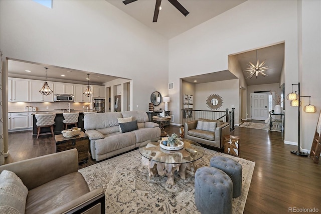 12590 Valentia St, Thornton, CO 80602 - living room with high vaulted ceiling, dark wood-style floors, baseboards, and a ceiling fan