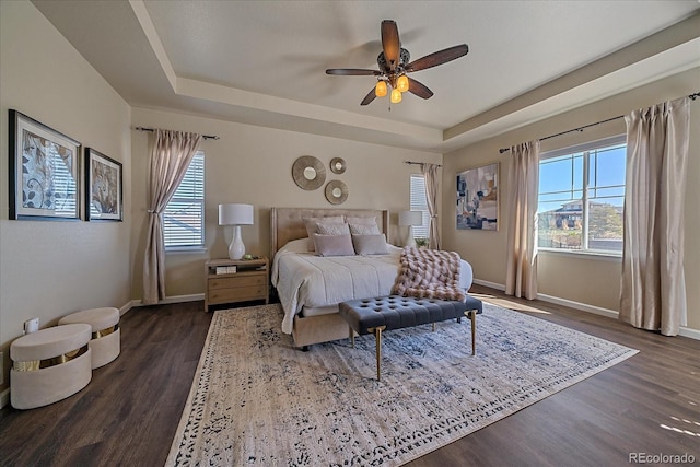 12590 Valentia St, Thornton, CO 80602 - bedroom with a tray ceiling, dark wood-type flooring, baseboards, and ceiling fan