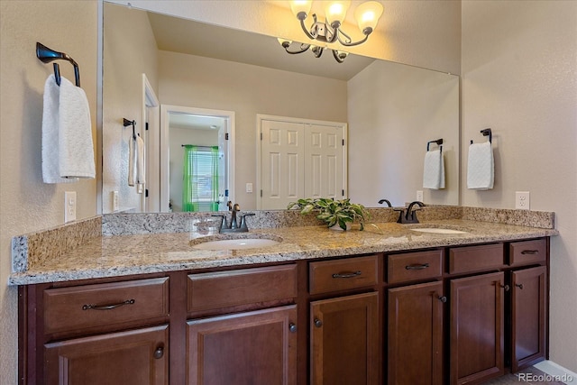 12590 Valentia St, Thornton, CO 80602 - bathroom with double vanity and a chandelier