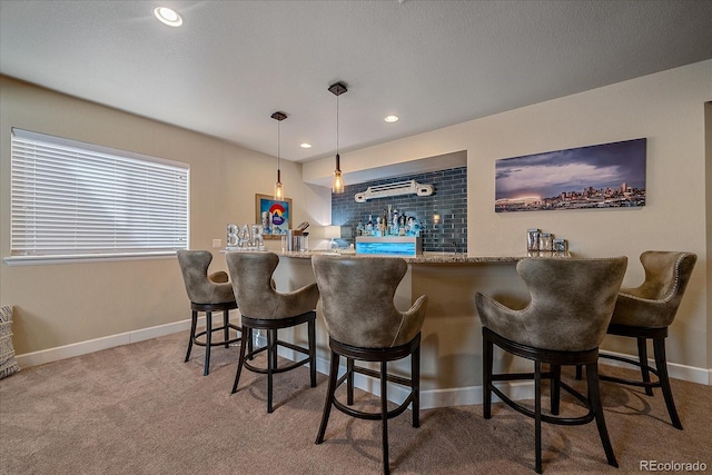 12590 Valentia St, Thornton, CO 80602 - indoor bar featuring carpet flooring, baseboards, recessed lighting, and pendant lighting