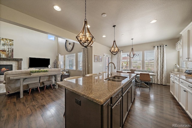 12590 Valentia St, Thornton, CO 80602 - kitchen featuring a sink, a chandelier, plenty of natural light, light stone counters, and recessed lighting