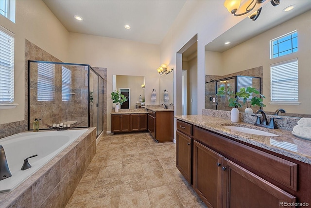12590 Valentia St, Thornton, CO 80602 - bathroom with a shower stall, two vanities, a bath, and recessed lighting