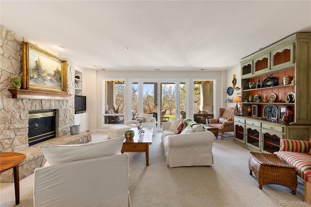 living room featuring a fireplace and carpet floors