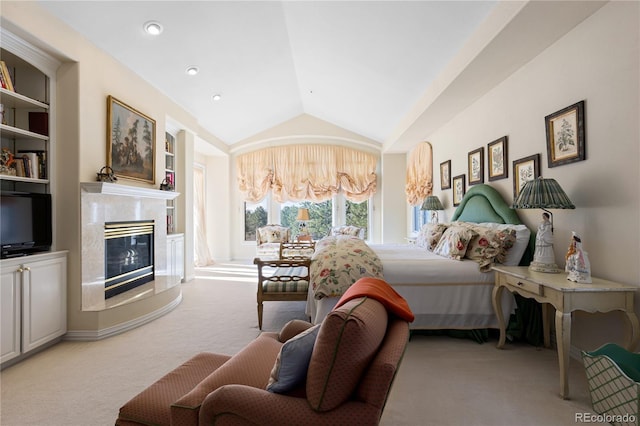 bedroom with a high end fireplace, access to exterior, light colored carpet, and vaulted ceiling
