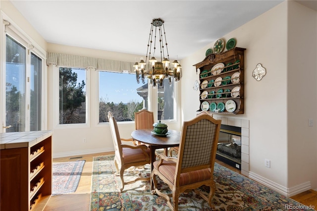 dining area with an inviting chandelier, baseboards, and a healthy amount of sunlight