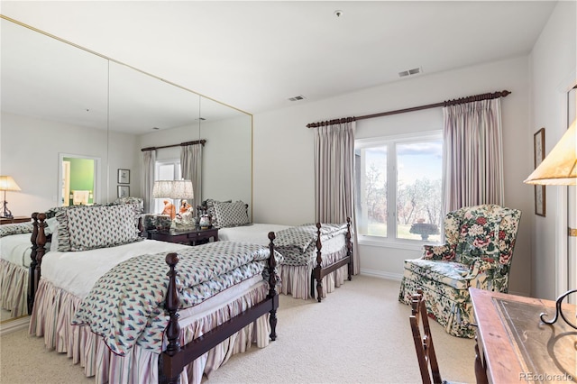 bedroom featuring multiple windows, light carpet, baseboards, and visible vents