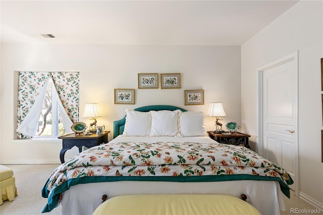 bedroom with carpet flooring, baseboards, and visible vents