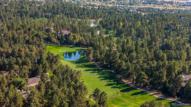 bird's eye view featuring a water view, a forest view, and golf course view
