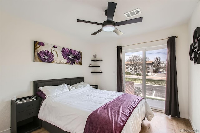 bedroom featuring visible vents, wood finished floors, baseboards, and ceiling fan