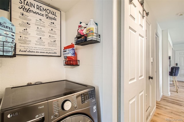 washroom featuring laundry area and wood finished floors