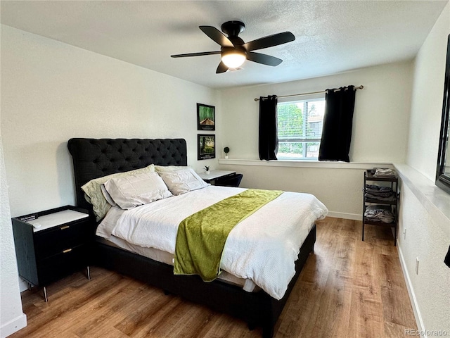 10785 W 63rd Pl Unit 108, Arvada, CO 80004 - bedroom featuring wood finished floors, a ceiling fan, and baseboards