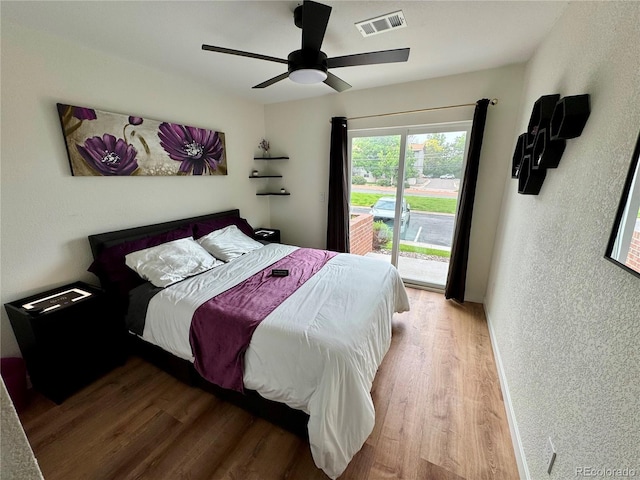 10785 W 63rd Pl Unit 108, Arvada, CO 80004 - bedroom featuring wood finished floors, access to outside, a textured wall, and ceiling fan