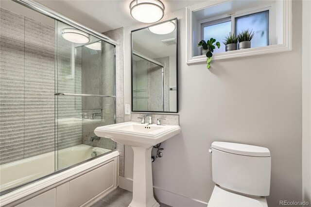 814 S High St, Denver, CO 80209 - bathroom featuring toilet and combined bath / shower with glass door