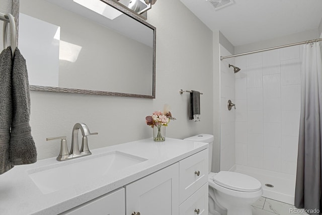 bathroom with toilet, a stall shower, marble finish floors, and vanity