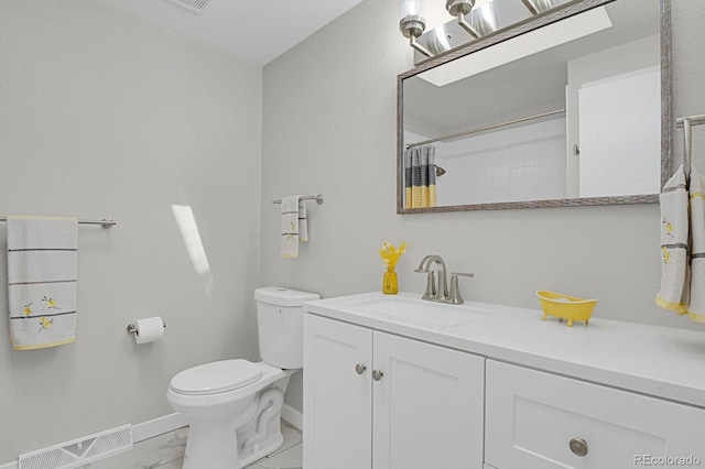 full bathroom featuring toilet, baseboards, marble look tiles, vanity, and curtained shower
