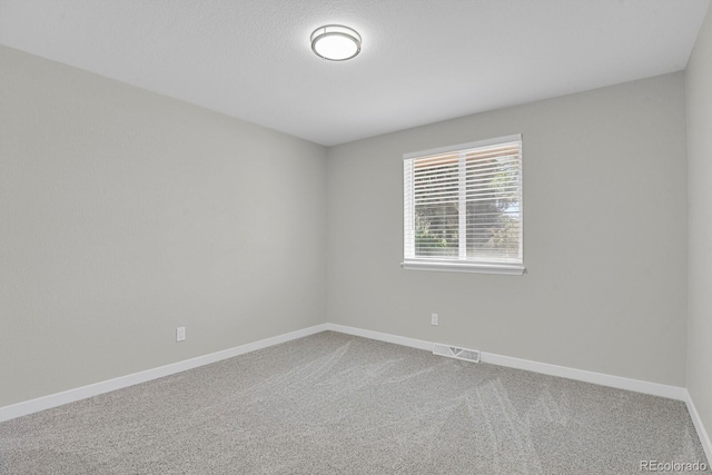 unfurnished room featuring carpet flooring and baseboards