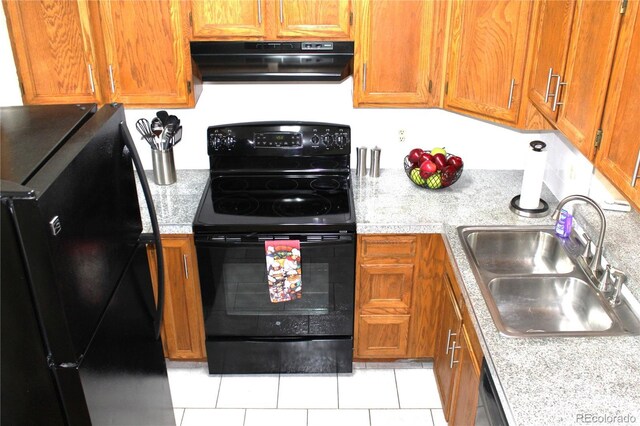 kitchen featuring a sink, ventilation hood, light countertops, brown cabinetry, and black appliances