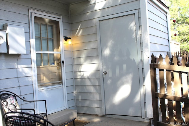 entrance to property featuring fence