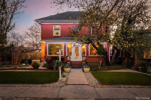 1521 Pontiac St, Denver, CO 80220 - american foursquare style home with brick siding, fence, a shingled roof, and a front yard