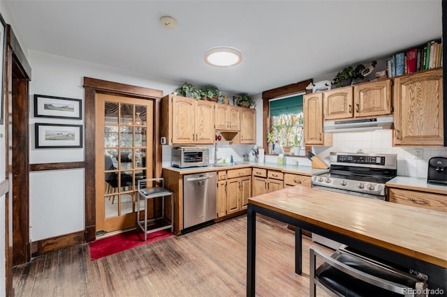 1521 Pontiac St, Denver, CO 80220 - kitchen with light brown cabinetry, stainless steel dishwasher, wood finished floors, under cabinet range hood, and butcher block countertops