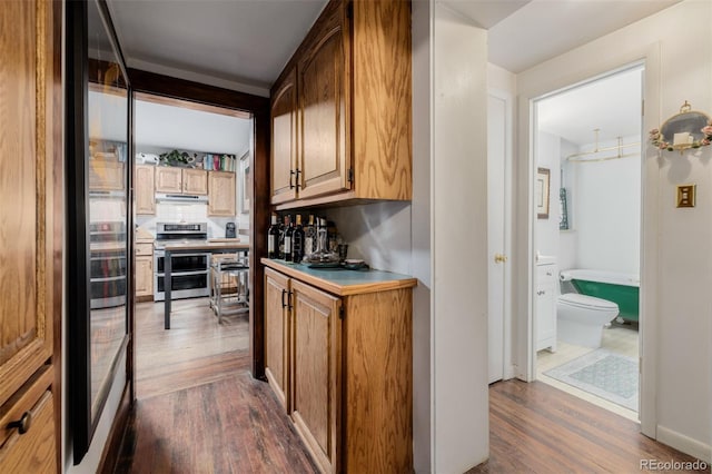 1521 Pontiac St, Denver, CO 80220 - bar featuring a bar, under cabinet range hood, dark wood-style floors, and range with two ovens