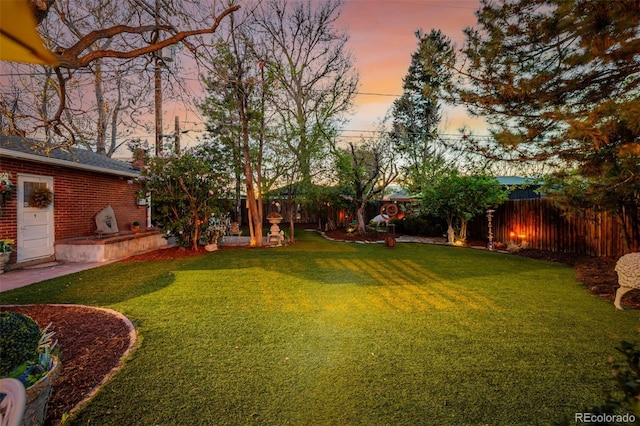 1521 Pontiac St, Denver, CO 80220 - yard at dusk with a fenced backyard