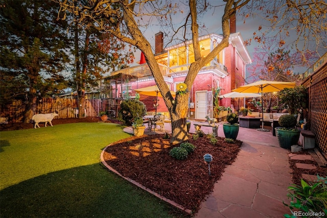 1521 Pontiac St, Denver, CO 80220 - view of yard featuring a fenced backyard, a patio, and a balcony