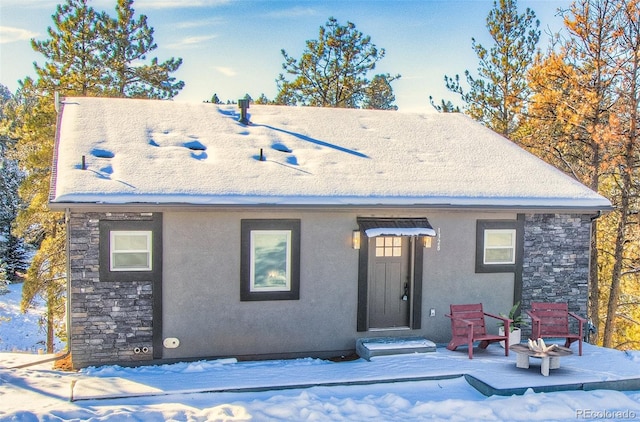 view of snow covered rear of property