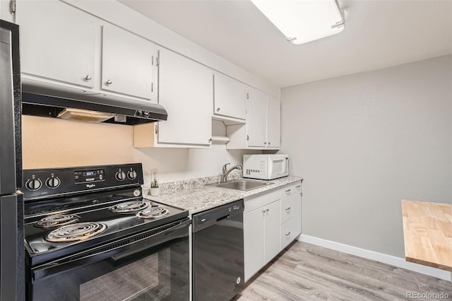 kitchen featuring sink, light wood-type flooring, black appliances, and white cabinetry